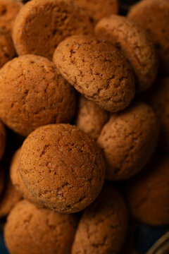Close-up top view of pile of kruidnoten cookies, typical Dutch treats for Sinterklaas , displaying their round shape and brown color, ideal for holiday celebrations Saint Nicholas day