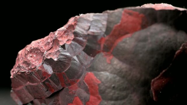 Hematite or Haematite (principal ore of iron) 'kidney ore' - sample against a black background.