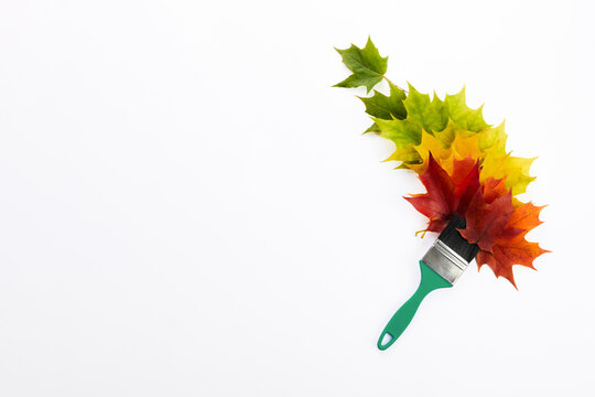 Paintbrush creating autumn leaves with color transition