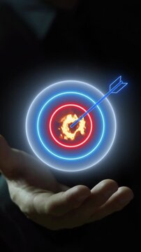 Businessman open hand vertical shot supporting glowing target bullseye with dart hit in center. Strategic financial profit goal achievement, investment revenue targeting, and wealth return concept.