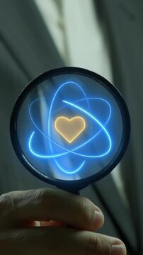 Close-up vertical shot of hand holding magnifying glass inspecting glowing heart icon inside atom orbits. Healthcare medical technology innovation audit, life science research, and wellness care conce