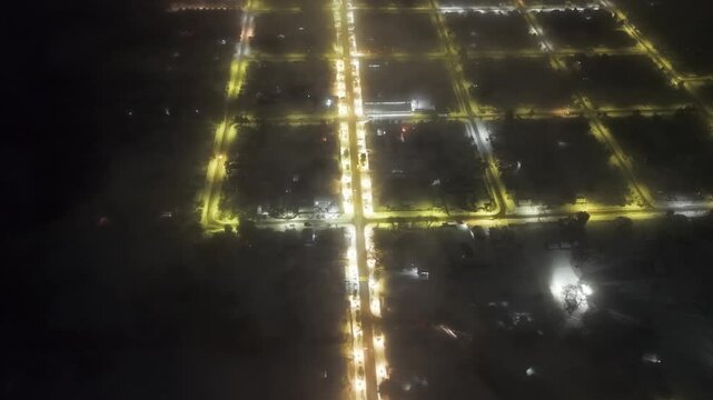 Aerial view of the perfect grid layout of the small town of Melipeuco at night, with its streets lit up, Andean Araucania, Chile