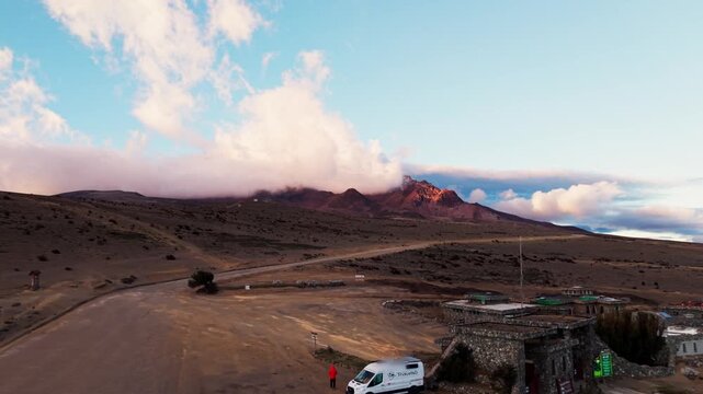 Majestic aerial view of the chimborazo volcano and a mountain refuge in the andes of ecuador