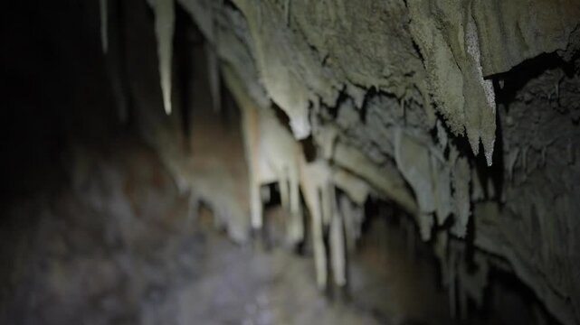 Close up view of the natural formation of stalactites in a dark cave