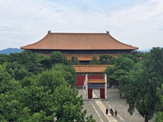 Fototapeta premium Grand imperial hall surrounded by trees at the Ming Tombs near Beijing