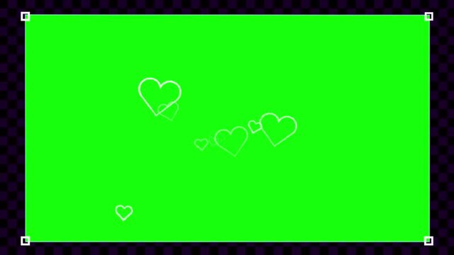 Green screen chroma key background displays outline heart icons floating with corner tracking markers.