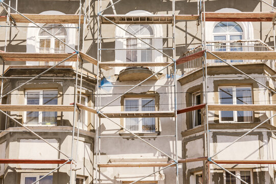 Building Facade Renovation with Scaffolding and Plaster Repairs