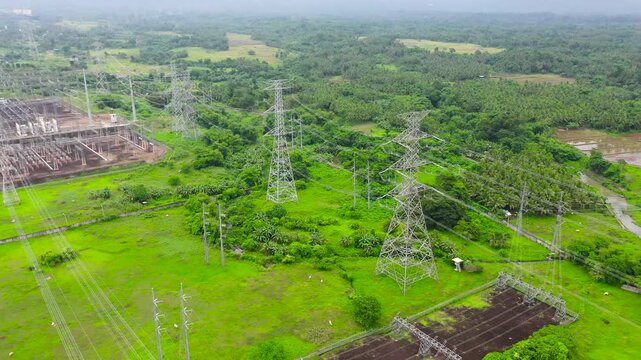 Electrical distribution substation. Distributing high voltage power substation in regional town viewed from above on a block of land made of insulators, poles, wires and transformers. Flying over