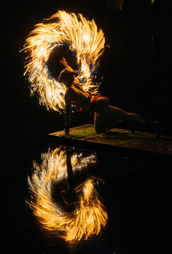 Fire African American performer spinning flaming fire