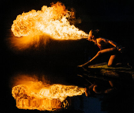 Fire African American performer breathing fire with dramatic