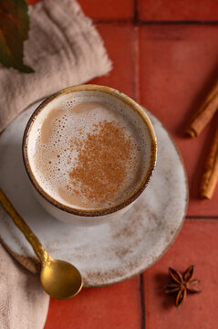 Masala chai latte with cinnamon foam, autumn spiced drink