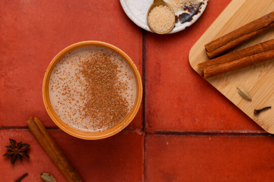 Spiced chai tea with cinnamon sticks, autumn flat lay drink