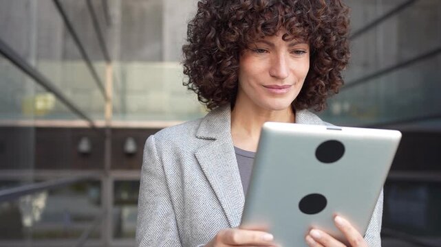 A professional woman uses a tablet in a modern office, highlighting her career aspirations