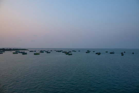 Sea view from Pamban Road Bridge with a cluster of small boats in Rameswaram, Tamil Nadu, India