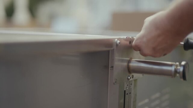 Close-up of stainless steel outdoor kitchen corner being assembled