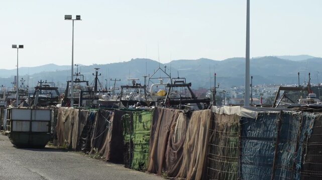 Fishing nets drying in metal cages at the harbor dock