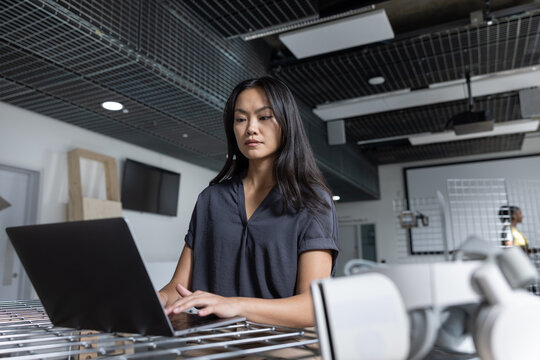 Woman Working Intently on Laptop for Project