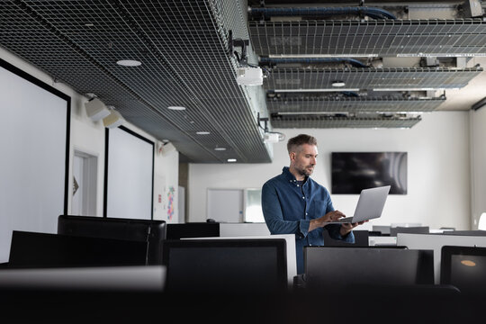 Man Working on Laptop in a Contemporary Office