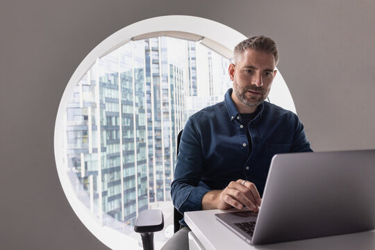 Focused Man in Minimalist Workspace Environment