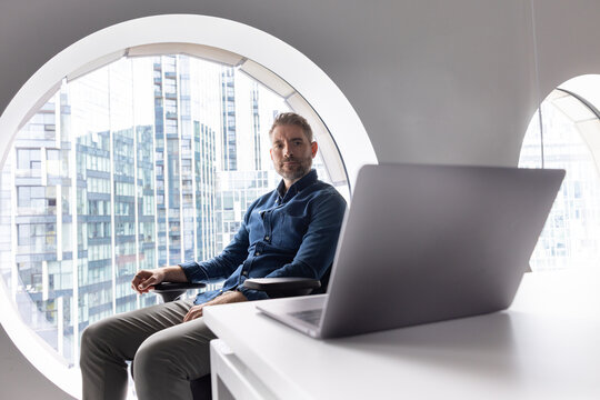 Meditative Man in Modern Office with City View