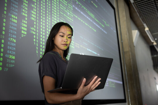 Young woman presenting tech data on big screen
