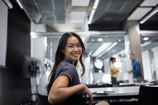 Young Woman Smiling While Working in a Modern Office