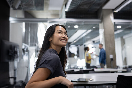 Bright Smiling Young Woman in a Meeting Room