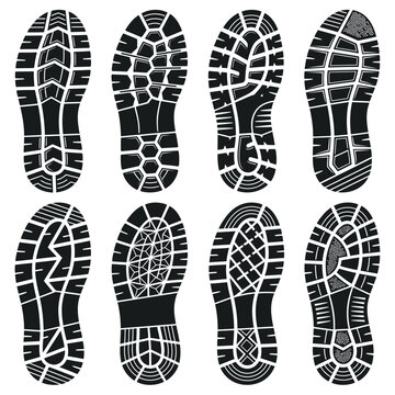 Set of eight black shoe sole prints with various tread patterns.
