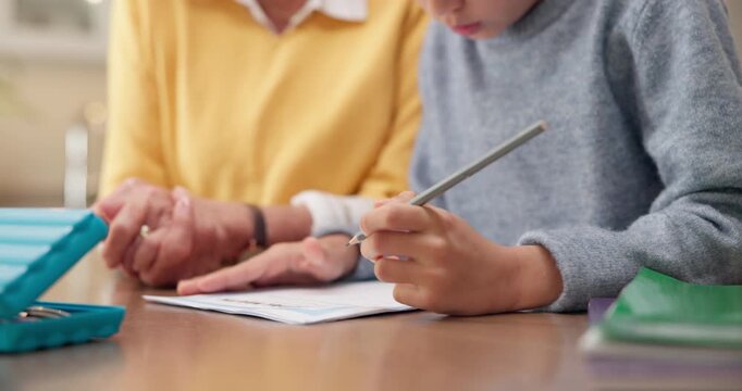 Homework, hands and grandparent with child in home for writing, study and learning for development. Family, house and kid with grandmother for help with assessment for education, knowledge and growth