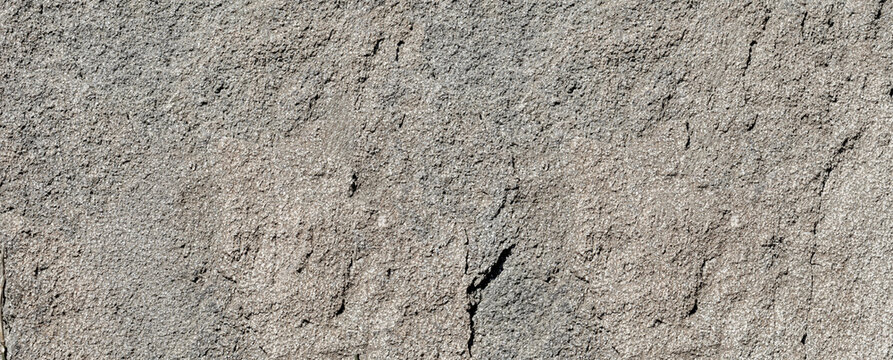 Rough natural gray granite rock wall texture