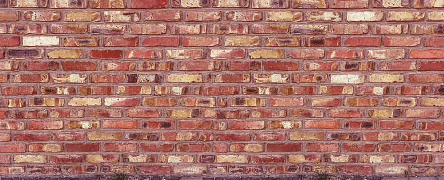 Red brick wall displaying rustic textured surface