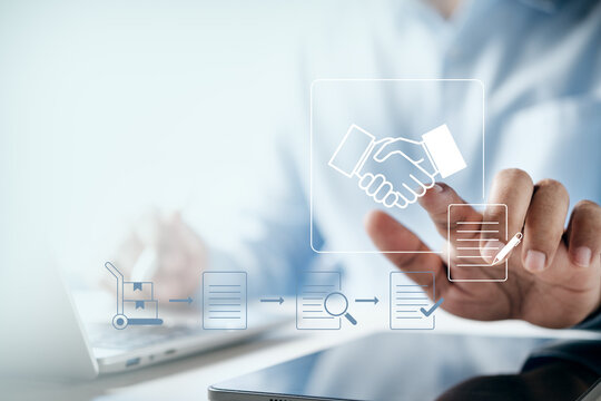 Businessman pointing at digital handshake icon with supply chain process flow graphics, concept of business partnership, agreement, logistics, E-commerce, and global trade.
