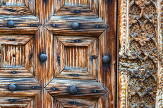 Antique wooden door with metal studs and intricate carvings in the historical district of Istanbul Turkey