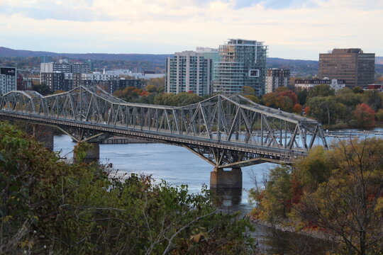 Parliament Hill Peace Tower and Rideau Canal locks with historic Rideau Hall, Alexandra Bridge, and Notre-Dame Cathedral Basilica in Ottawa, Ontario, Canada autumn travel destination landmark view.