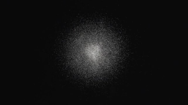 Merging two speckle clusters appearing near center, forming expanding luminous cloud on black field