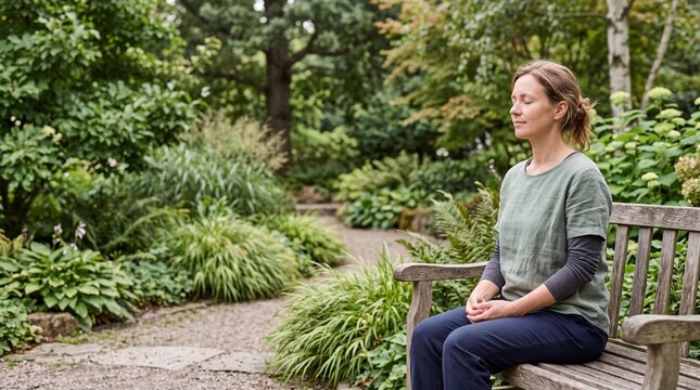 Woman practicing mindfulness meditation in a peaceful garden