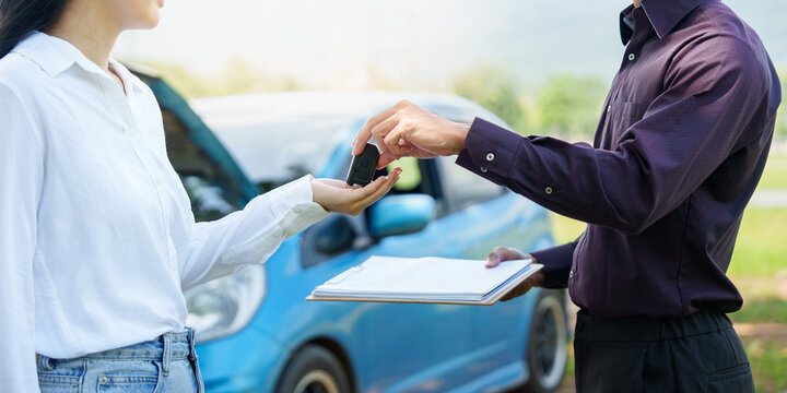 Handover of car key between agent and customer for vehicle rental or sale