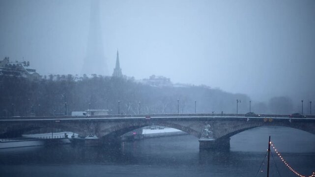 Winter scene in Paris with snow falling over a historic stone bridge and the Seine river, boats docked along the riverbank, and the Eiffel Tower barely visible through the snowstorm.
