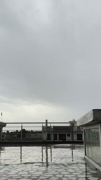 Time lapse of Rainy Rooftop with Dark Mansoon Clouds and Falling Raindrops