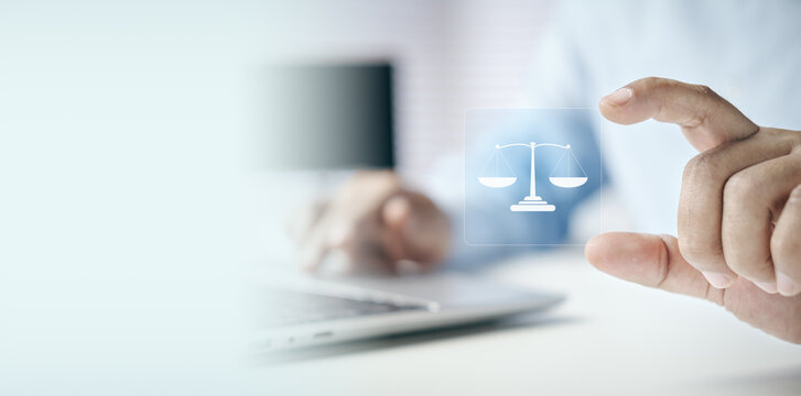 Businessman holding a digital scale of justice icon on white background with copy space, concept of law, legal advice, justice, ethics, compliance, and corporate governance.
