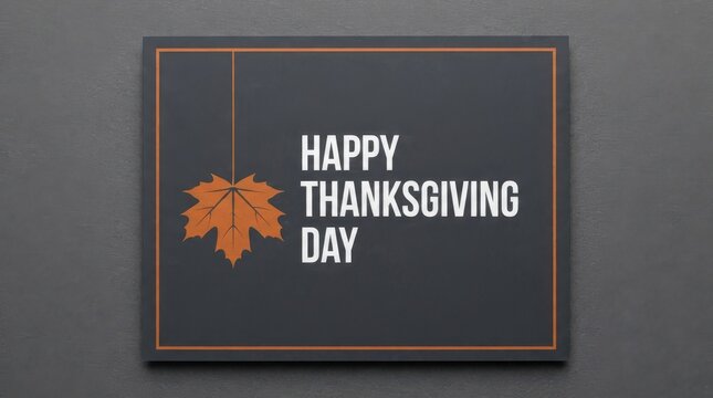 Minimalist happy thanksgiving card with a single orange maple leaf hanging on a string against a dark grey textured background