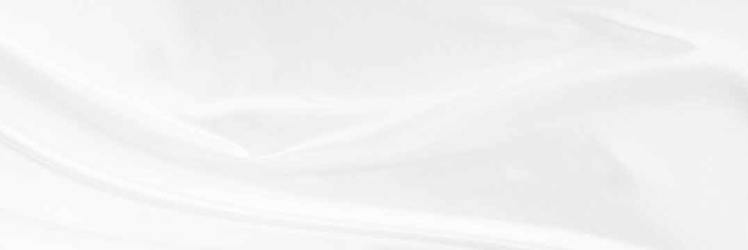 White gray satin texture that is white silver fabric silk panorama background with beautiful soft blur pattern natural.