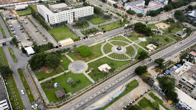 Aerial view of Johnson Jakande Tinubu JJT Park featuring lush green lawns, a central circular plaza, and paved walkways surrounded by urban roads in Ikeja, Lagos, Nigeria.