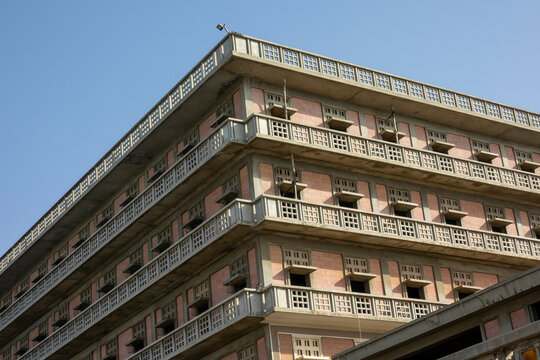 Rows of weathered balconies line the upper corner of the abandoned Saint George Hotel against a clear blue sky, Beirut Governorate, Beirut, Lebanon