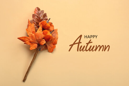 Top view of bouquet of pumpkins and autumn leaves and text Happy Autumn. Autumn concept background