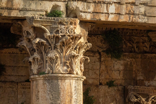A weathered Corinthian column capital displays intricate acanthus leaf carvings at the ancient Roman ruins, Baalbek-Hermel Governorate, Baalbek, Lebanon