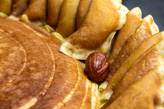 A folded pastry reveals a soft date filling nestled among golden baked dough, South Governorate, Tyre, Lebanon