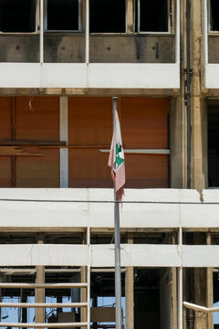 A torn Lebanese flag hangs from a pole in front of the Electricite du Liban headquarters building damaged by the 2020 Beirut port explosion, Beirut Governorate, Beirut, Lebanon