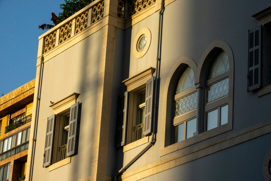 A restored heritage building showcases arched windows with wooden shutters and ornate stone carvings, Beirut Governorate, Beirut, Lebanon
