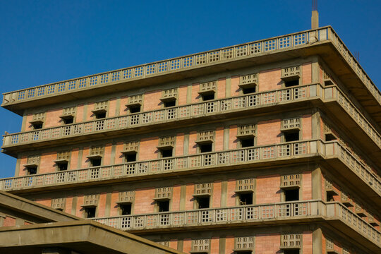 Rows of empty balconies line the corner of the abandoned war-damaged Saint George Hotel under a clear blue sky, Beirut Governorate, Beirut, Lebanon